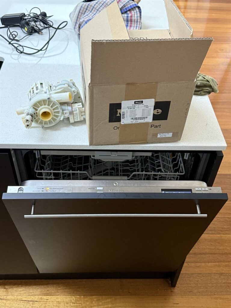 Miele dishwasher circulation pump beside the genuine Miele spare part box