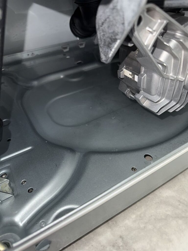 Base of the Miele washing machine, where leaked water collected in the drip tray